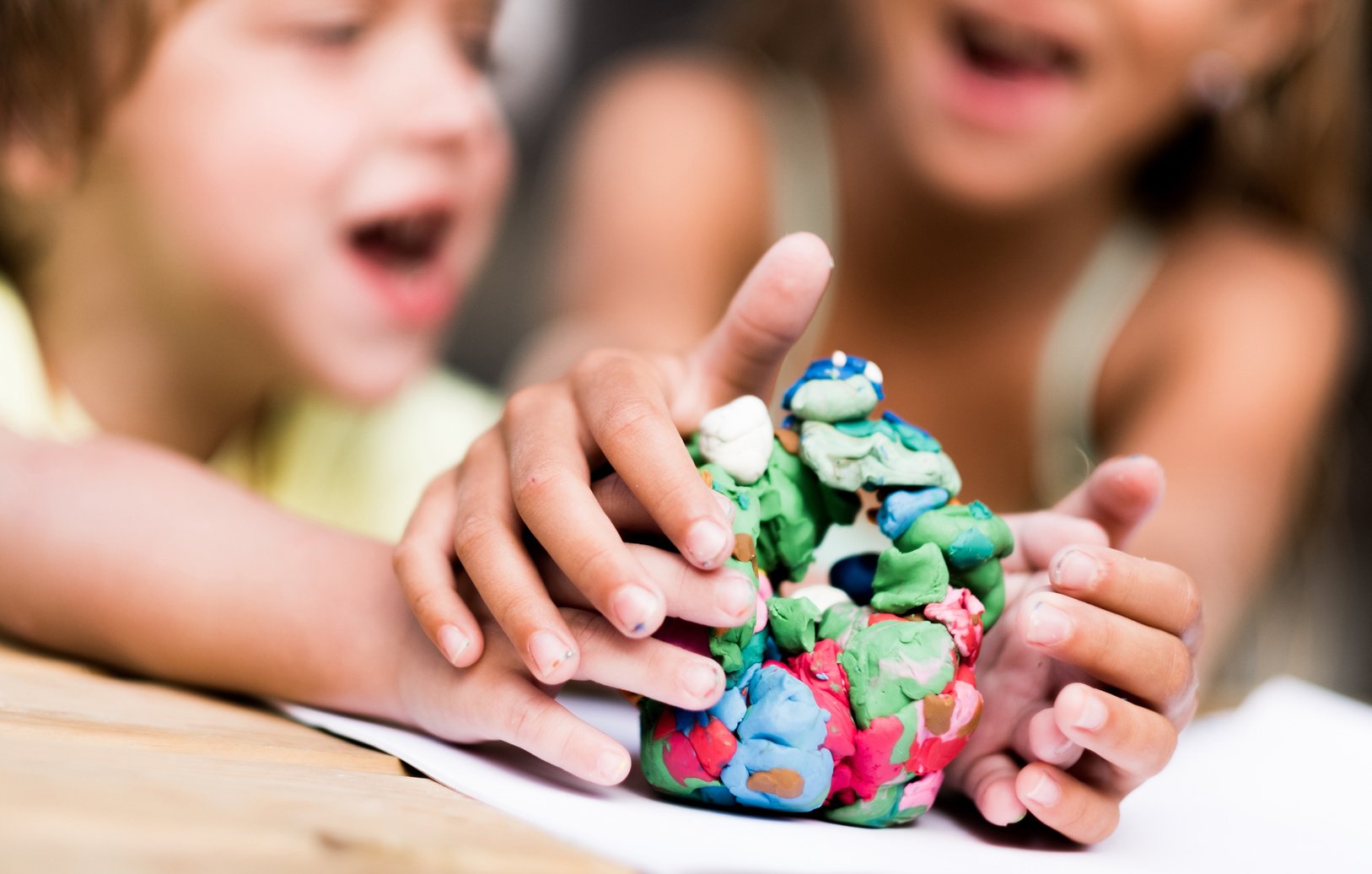 Children arguing about play dough